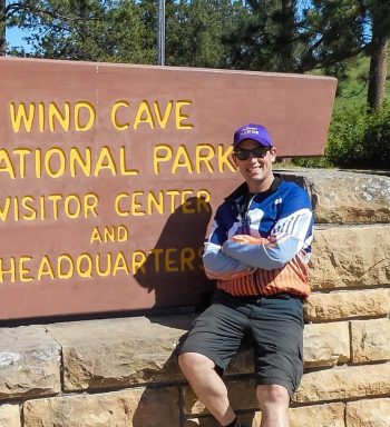 man in front of wind cave