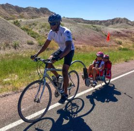 Man biking with kids on Mt. Rushmore Family Tour