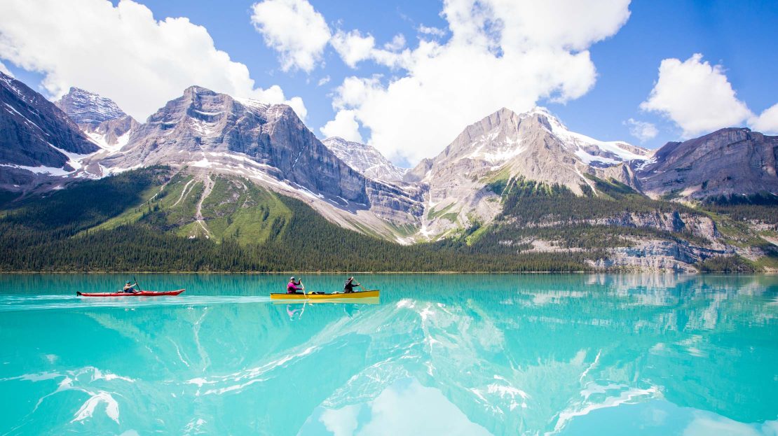 Two people kayaking in a glacier